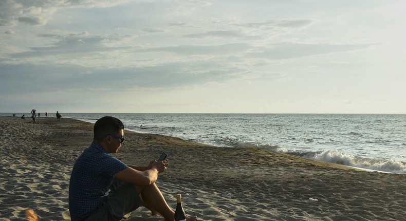 Carlo Almendral, the chief executive of an artificial intelligence start-up, at the beach in the Philippines.MARIA TAN/AFP via Getty Images