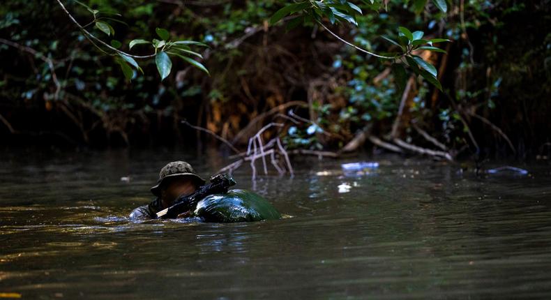 A Marine Raider with Marine Forces Special Operations Command traverses a river during a jungle mobility course, Aug. 4, 2023.U.S. Marine Corps photo by Cpl. Henry Rodriguez