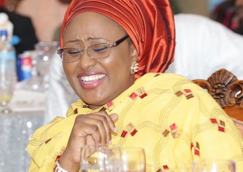 Mrs. Aisha Buhari laughs at a dinner (Presidency) 