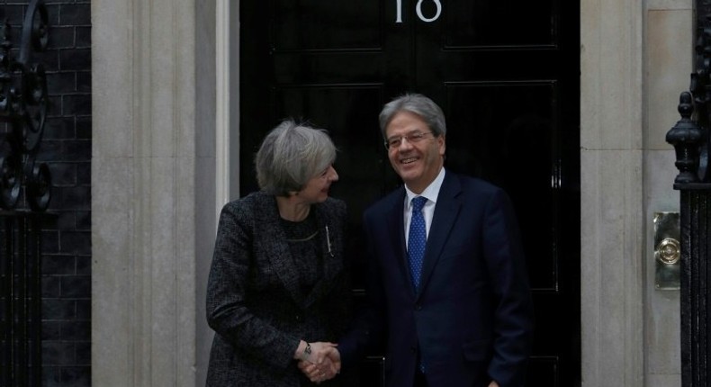 British Prime Minister Theresa May shakes hands with her Italian counterpart Paolo Gentiloni outside No. 10 Downing Street in London, on February 9, 2017