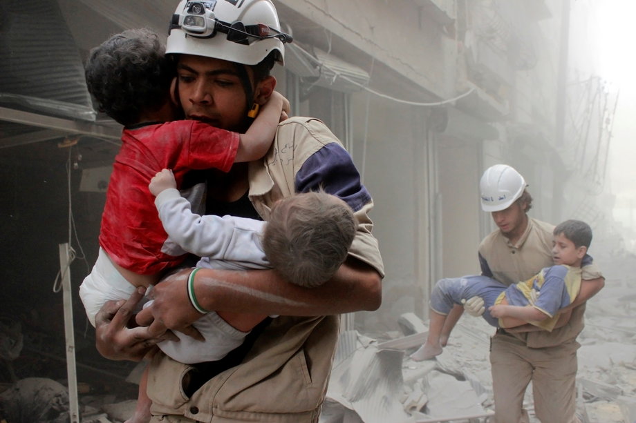 Members of the Civil Defence rescue children after what activists said was an air strike by forces loyal to Syria's President Bashar Assad in an Aleppo neighborhood in June 2014.