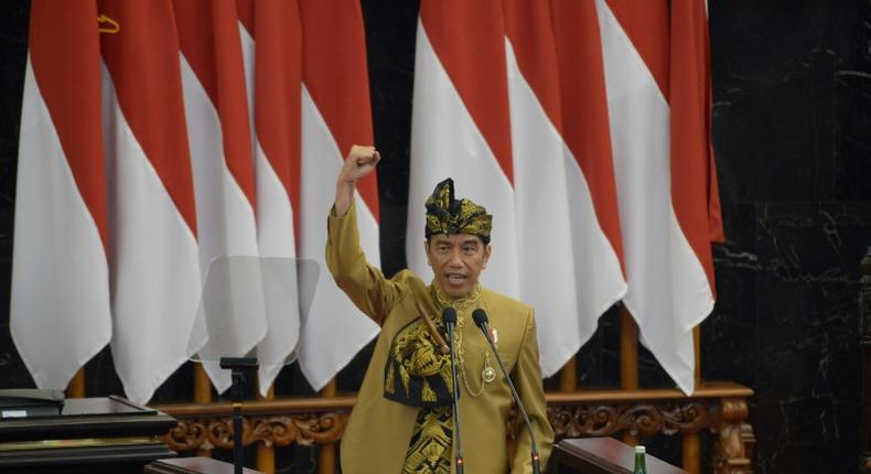 President Joko Widodo, wearing a traditional outfit for his address, wants to relocate the Indonesian capital to the island of Borneo but did not give a timetable for the move