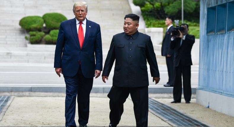 North Korea's leader Kim Jong Un and US President Donald Trump cross south of the Military Demarcation Line that divides North and South Korea, after Trump briefly stepped over to the northern side, on June 30, 2019