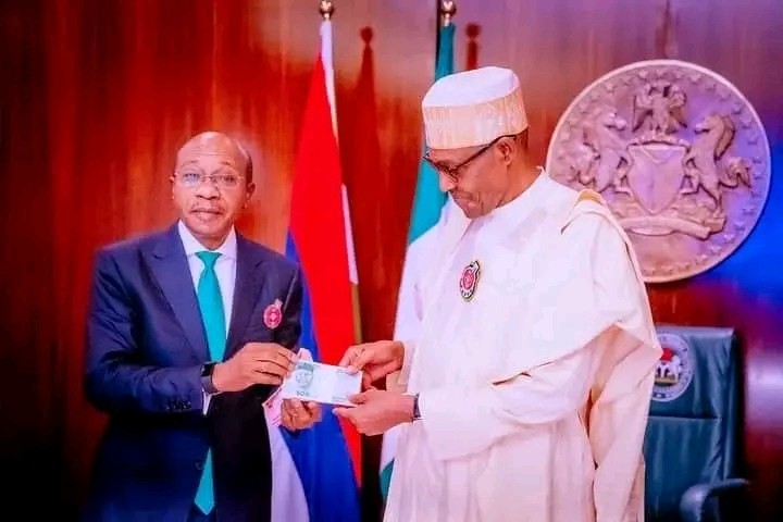 CBN Governor Godwin Emefiele and President Muhammadu Buhari during the unveiling of the redesigned naira notes. (Daily Trust)