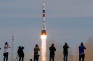 Photographers take pictures as Soyuz MS-04 spacecraft carrying the crew of Fischer of the U.S. and Yurchikhin of Russia as it blasts off to ISS from the launchpad at the Baikonur Cosmodrome