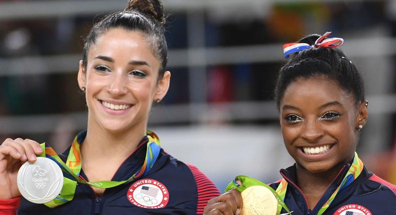 Aly Raisman (L) and Simone Biles (R) pose with their Olympic medals in 2016.TOSHIFUMI KITAMURA/AFP via Getty Images