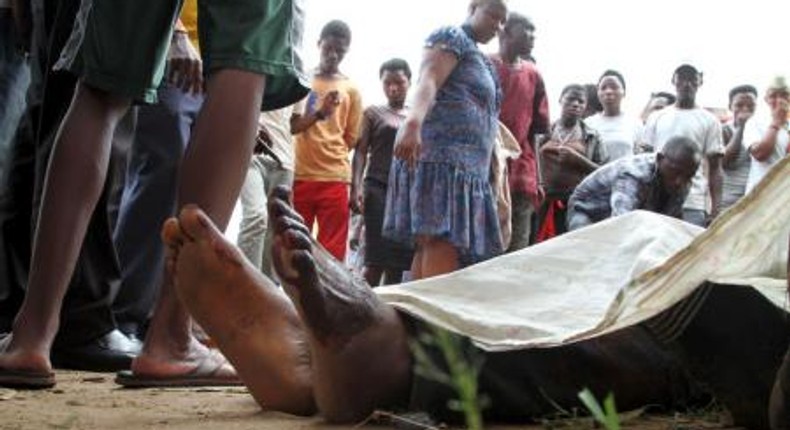 Residents look at the slain bodies of people killed at the Cibitoke district in Burundis capital Bujumbura, December 9, 2015.