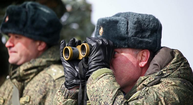 Major General Andrei Sukhovetsky (R), commander of the Novorossiysk guards mountain air assault division of the Russian Airborne Troops, looks through binoculars during an exercise at Opuk range.

