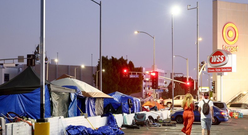 People walk past a homeless encampment near a Target store on September 28, 2023 in Los Angeles, California.Mario Tama/Getty Images