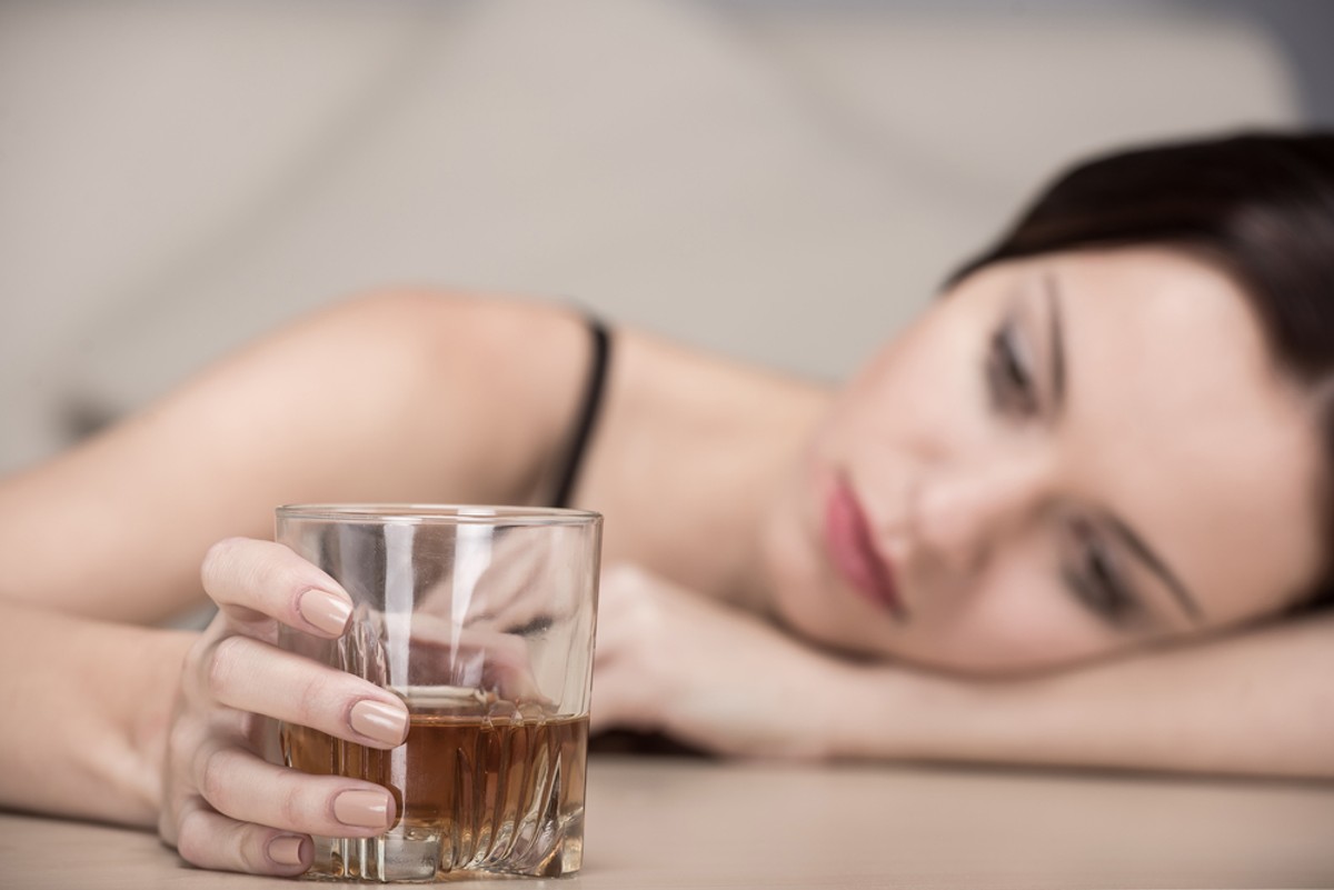 Kobieta pije alkohol.