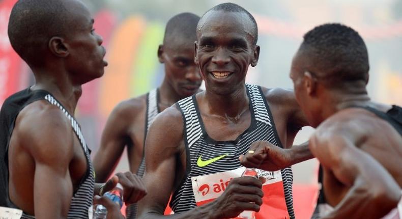 Kenyan Olympic gold medallist marathon runner Eliud Kipchoge (C) is one of three top runners selected by Nike to make the marathon record attempt later this year