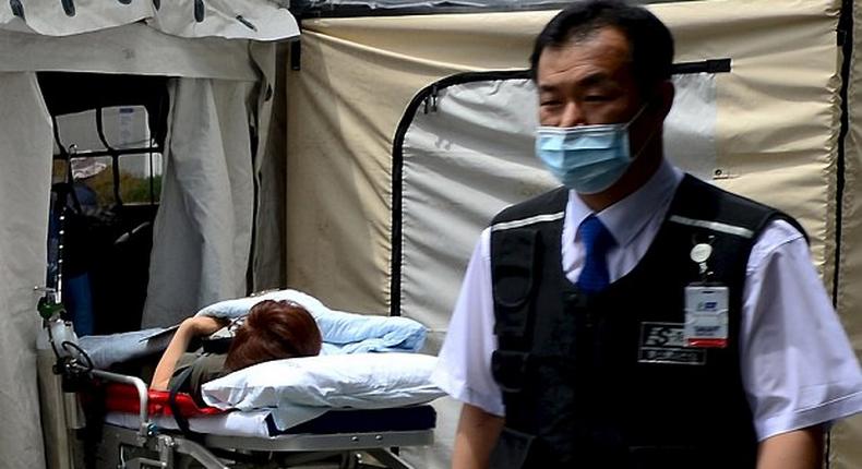 A woman, who is believed to be infected with Middle East Respiratory Syndrome (MERS), lies on a stretcher in a quarantine area set up in a hospital in Seoul, South Korea.