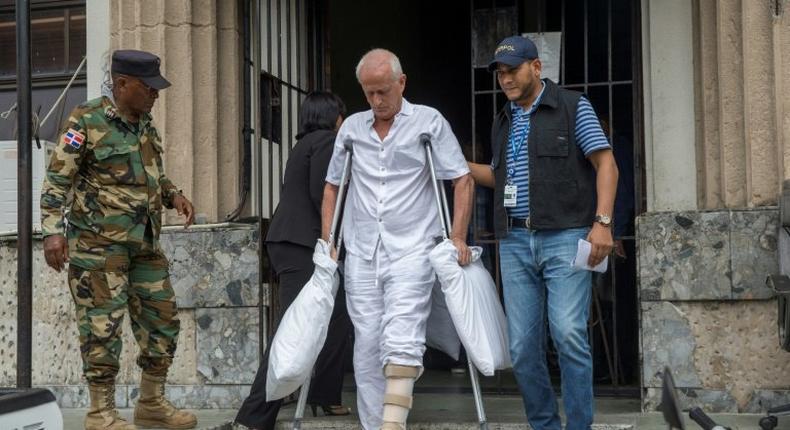 Frenchman Alain Castany (C), sentenced to 20 years for drug trafficking in the Air Cocaine case, leaving prison in Santo Domingo to be transferred to France for medical reasons