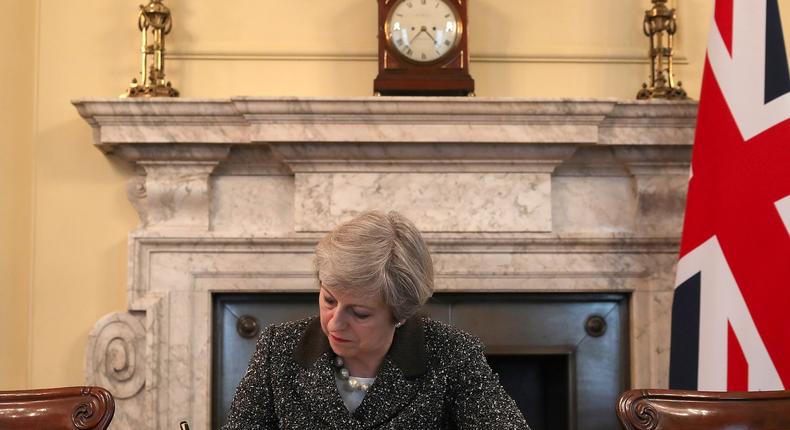 British Prime Minister Theresa May in the cabinet office signing the official letter to European Council President Donald Tusk invoking Article 50 and the UK's intention to leave the European Union.