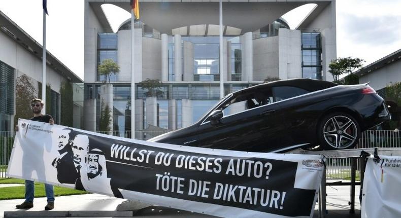 'Do you want this car? Kill dictatorship!' asks the slogan on the art installation outside Merkel's office, along with pictures of Erdogan, Putin, and King Salman