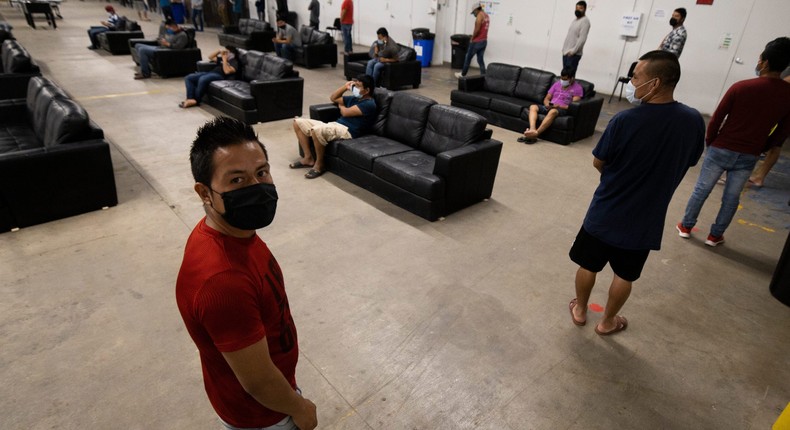 Migrant farm laborers with Fresh Harvest working with an H-2A visa line up for a meal in the company living quarters on April 28, 2020 in King City, California.
