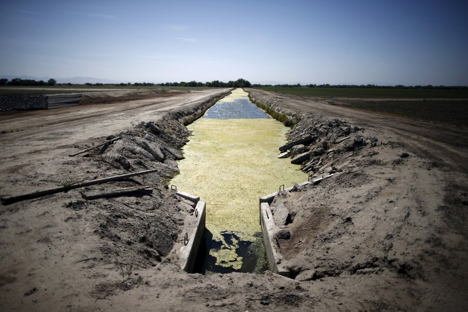 A canal runs through dwindling farm fields in Los Banos.