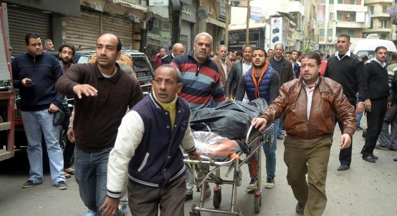 A body is wheeled away near a church in Alexandria, Egypt after a bomb blast struck worshippers gathering to celebrate Palm Sunday on April 9, 2017