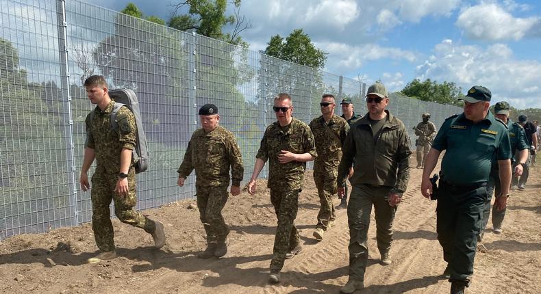 Latvian President (3rd from left) walks alongside a fence being built on Latvia's border with Russia on June 18, 2024.picture alliance