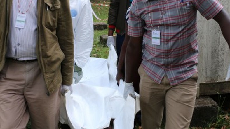 Police carrying a dead body from a crime scene