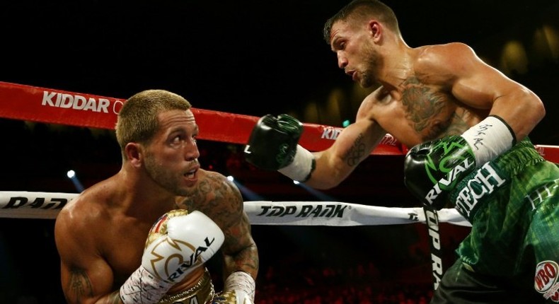 Jason Sosa (L) of the US exchanges punches with Vasyl Lomachenko of Ukraine during their WBO super featherweight world championship bout, at MGM National Harbor in Oxon Hill, Maryland, on April 8, 2017