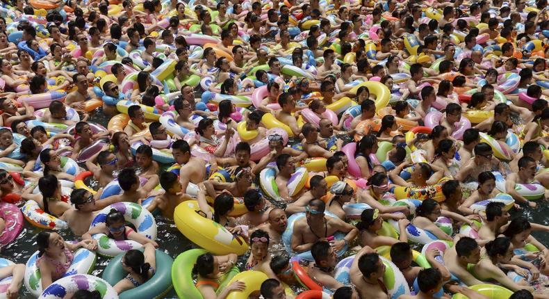 2015Visitors crowd an artificial wave swimming pool at a tourist resort to escape the summer heat in Daying county of Suining, Sichuan province, China, July 11, 2015.