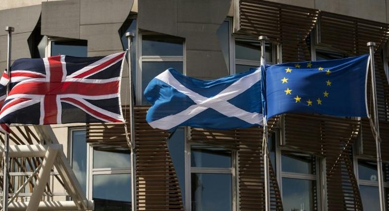 The British, Scottish and EU flags in front of the Scottish Parliament in Edinburgh