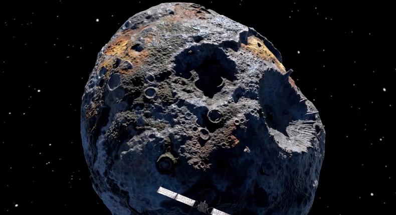 An artist's rendering of the Psyche spacecraft approaching a giant metal asteroid.