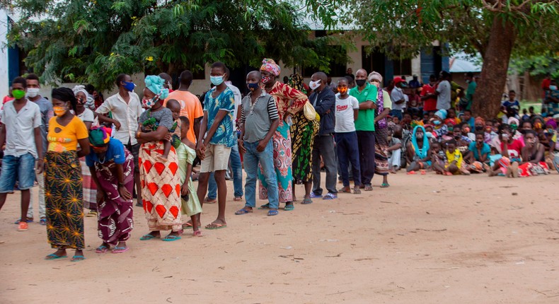 Internally displaced persons await in line during an United Nations World Food Program's distribution at the 3 de fevereiro escola school in Matuge district, northern Mozambique, on February 24, 2021