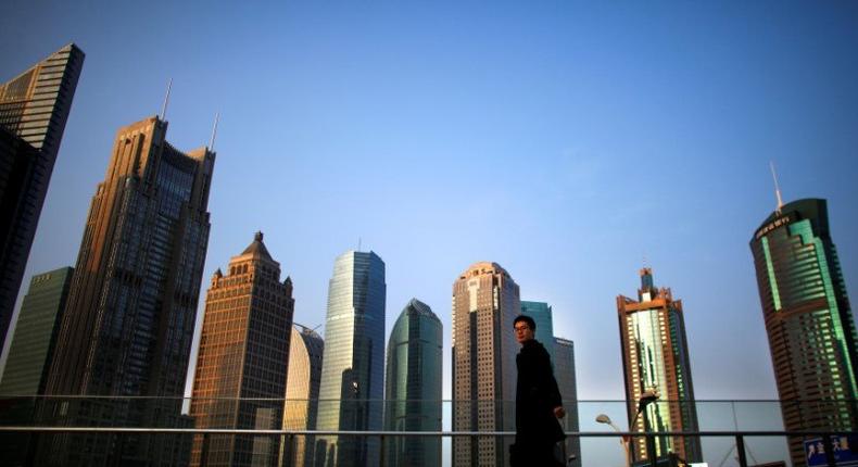 A man walks at the financial district of Pudong in Shanghai.