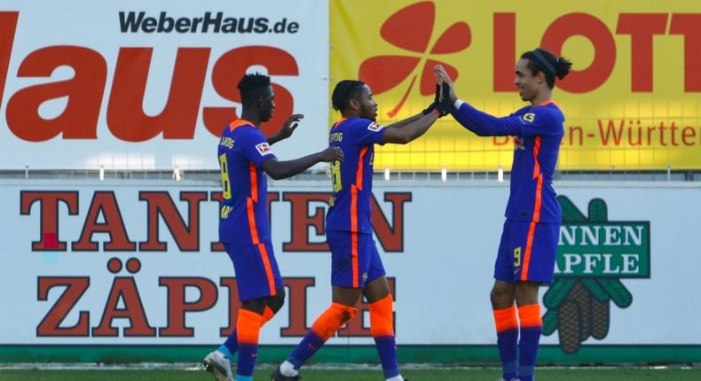 Christopher Nkunku (C) celebrates scoring for RB Leipzig at Freiburg on Saturday