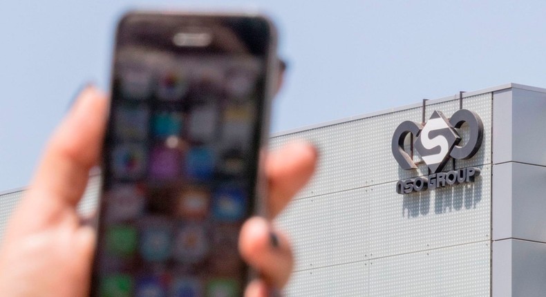 An Israeli woman uses her iPhone in front of the building housing the Israeli NSO group, on August 28, 2016, in Herzliya, near Tel Aviv.