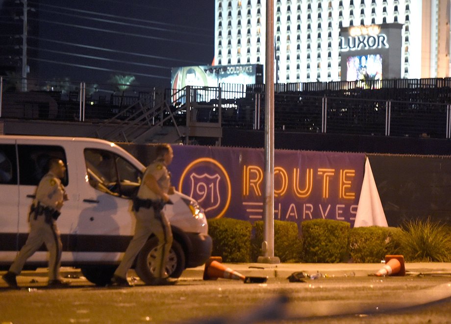 Las Vegas police run by a banner at the Route 91 Harvest country-music festival, October 2, 2017.