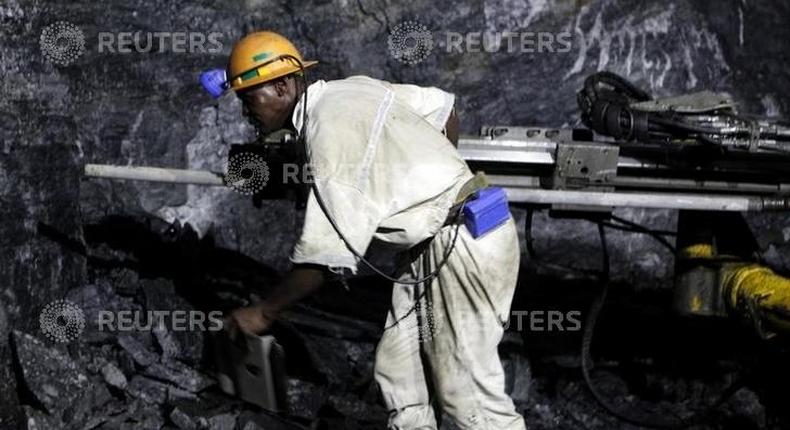 A mine worker is seen underground in South Deep mine outside Johannesburg June 4,2010. REUTERS/Siphiwe Sibeko