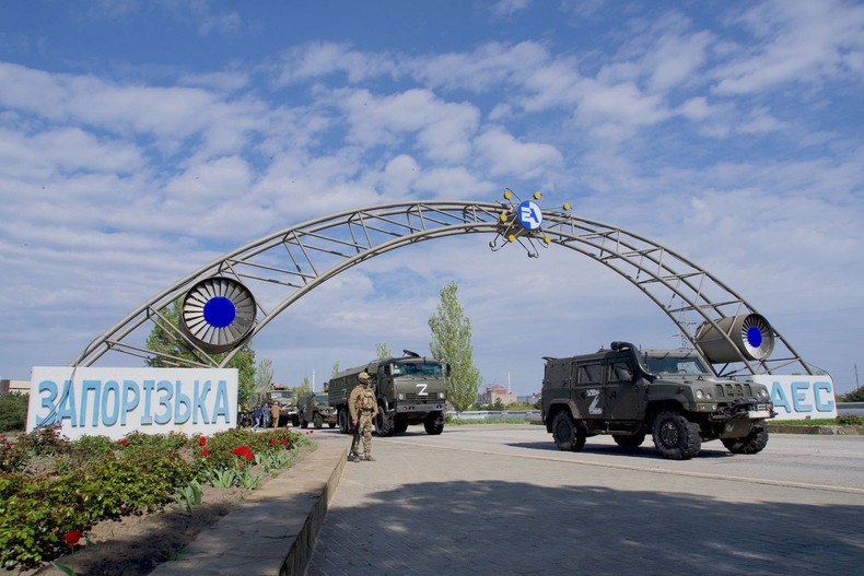 Russian military vehicles drive through the gates of the Zaporizhzhia nuclear power station in May 2022.ANDREY BORODULIN/AFP via Getty Images