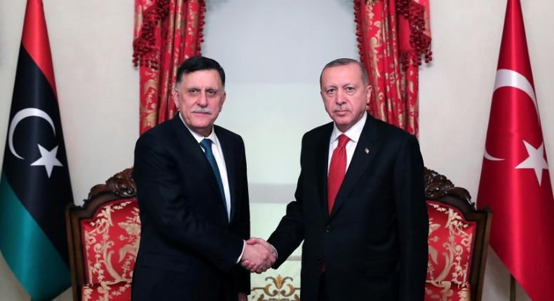 Turkish President Recep Tayyip Erdogan (R) meets with Fayez al-Sarraj, the head of the Tripoli-based Government of National Accord in Istanbul on November 27, 2019