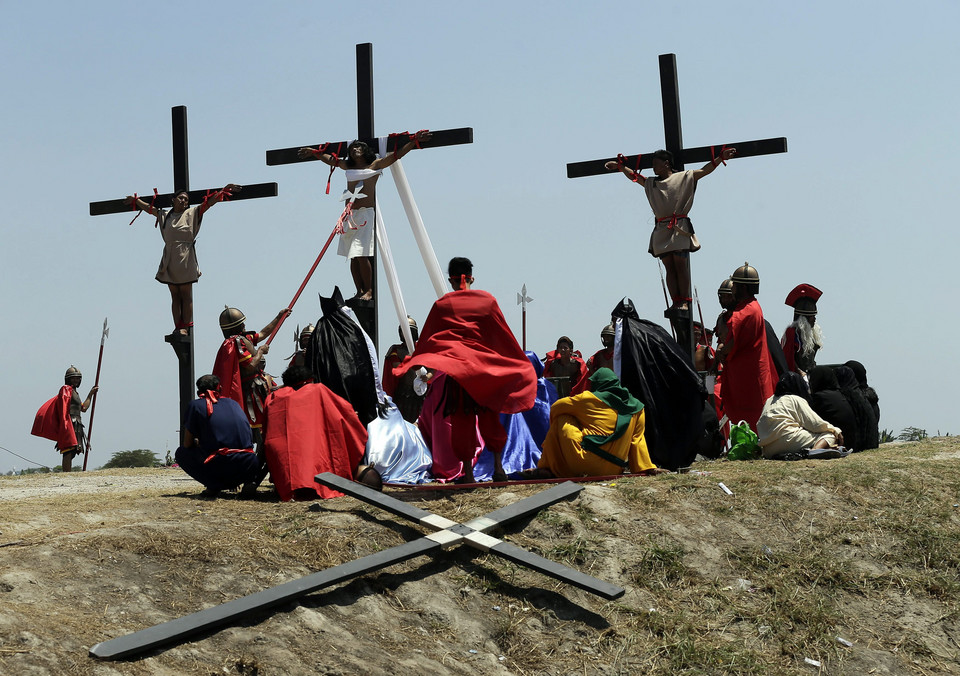 PHILIPPINES HOLY WEEK (Penitent is nailed to a wooden cross during the re-enactment of the crucifixion of Jesus Christ on Good Friday)
