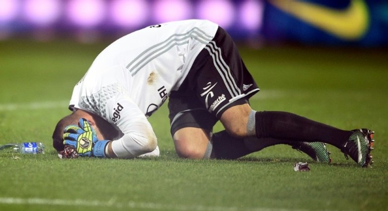 Lyon goalkeeper Anthony Lopes reacts after a firecracker exploded beside him during an away match against Metz on December 3, 2016