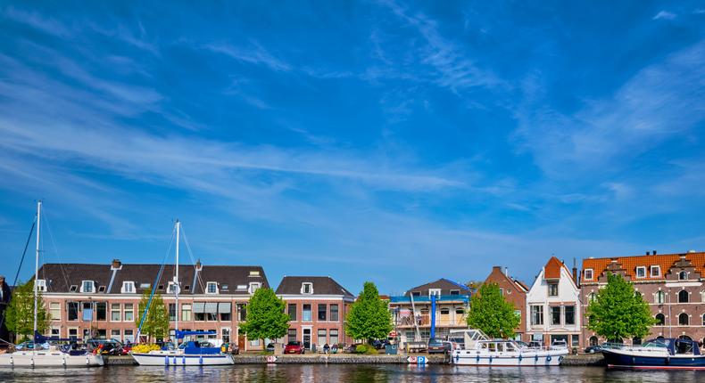 Boats and houses on Spaarne river, Haarlem, Netherlands