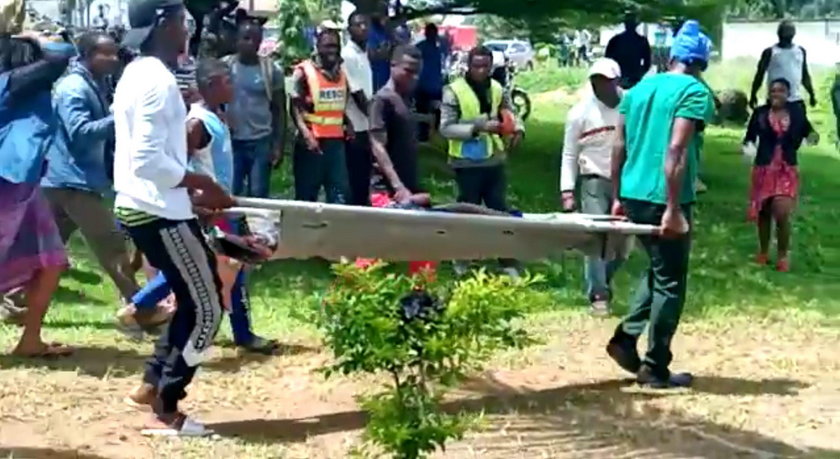 Body of a victim is carried following a shooting at a school in Kumba