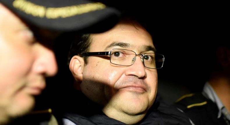 Javier Duarte (C), former governor of the Mexican state of Veracruz, in a police patrol car following his arrest upon his arrival at the Matamoros military barracks in Guatemala City on April 16, 2017
