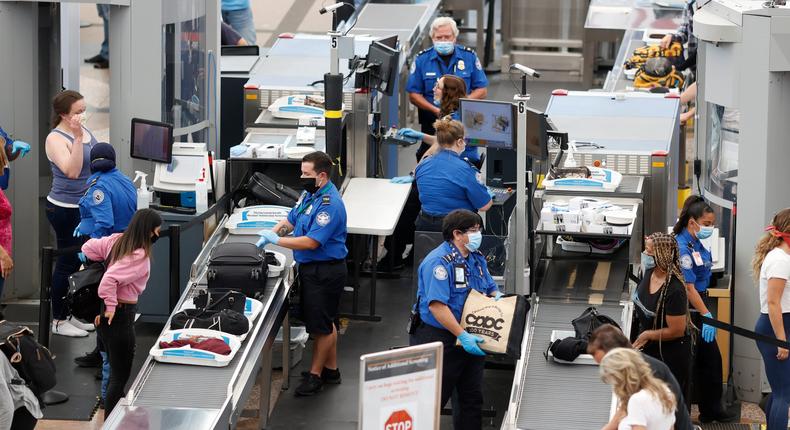 Transportation Security Administration agents process passengers at the south security checkpoint at Denver International Airport in Denver.