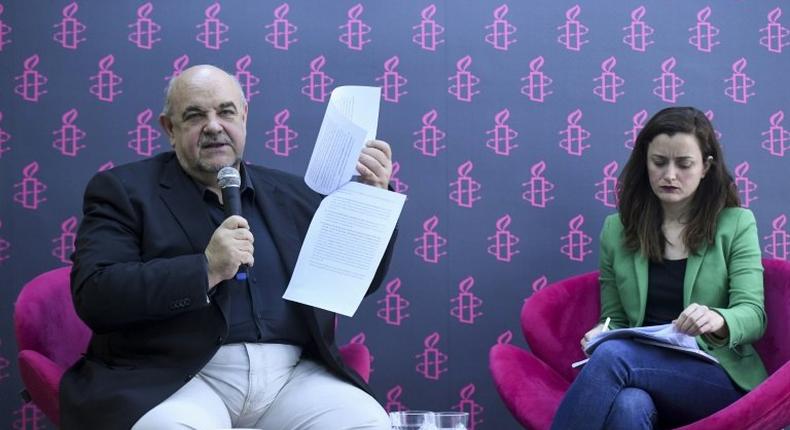 The director of Amnesty International Spain, Esteban Beltran (L), and the director of international justice policy at Amnesty International Argentina, Mariana Fontura Marques, present a report on violence in Venezuela