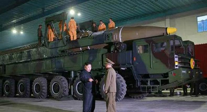 Kim Jong Un pictured in front of North Korea's first intercontinental ballistic missile.