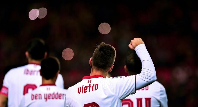 Sevilla's Luciano Vietto celebrates a goal with teammates during a match against Malaga CF at the Ramon Sanchez Pizjuan stadium in Sevilla on December 17, 2016