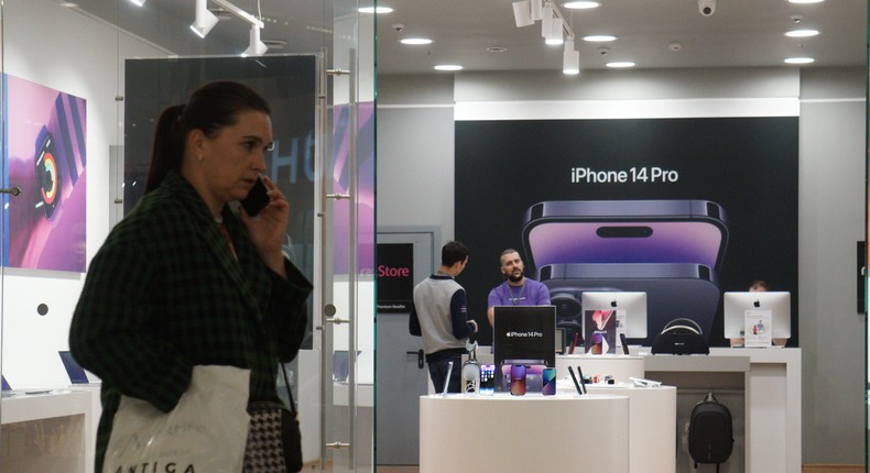 A woman walks past a store advertising a new Apple iPhone 14 Pro at a shopping mall in Moscow, Russia.Getty Images