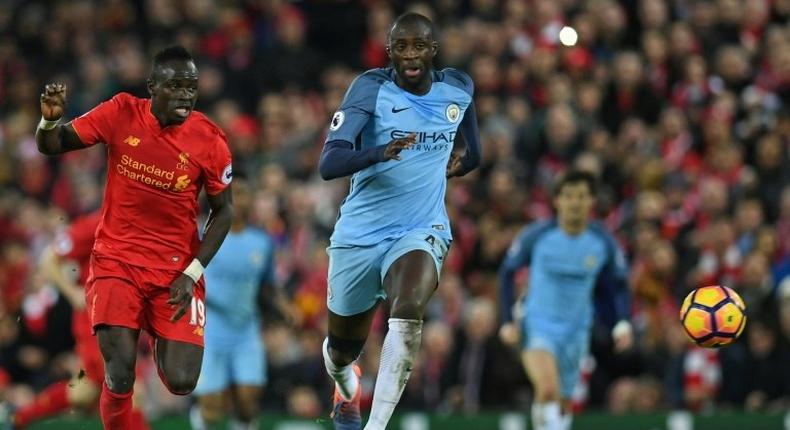 Liverpool's midfielder Sadio Mane (L) vies with Manchester City's midfielder Yaya Toure during the English Premier League football match December 31, 2016