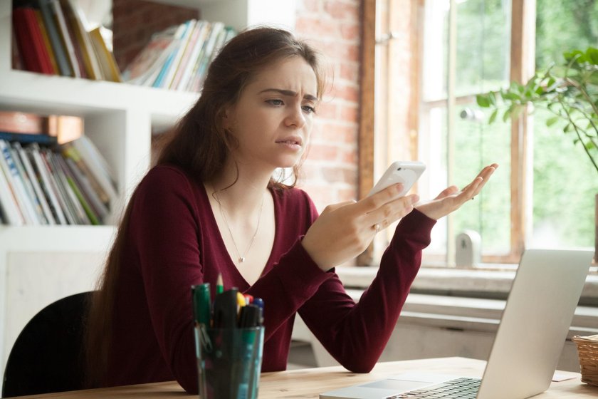 Annoyed frustrated woman having problem with not working mobile 