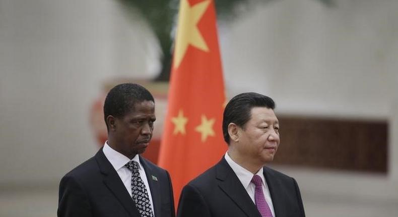 Zambia's President Edgar Lungu (L) and China's President Xi Jinping listen to their national anthems during a welcoming ceremony at the Great Hall of the People in Beijing, March 30, 2015. REUTERS/Jason Lee