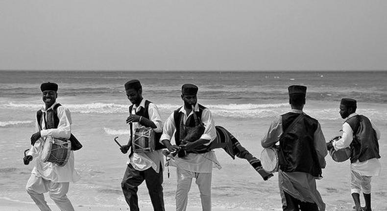 A band of musicians at a beach. 